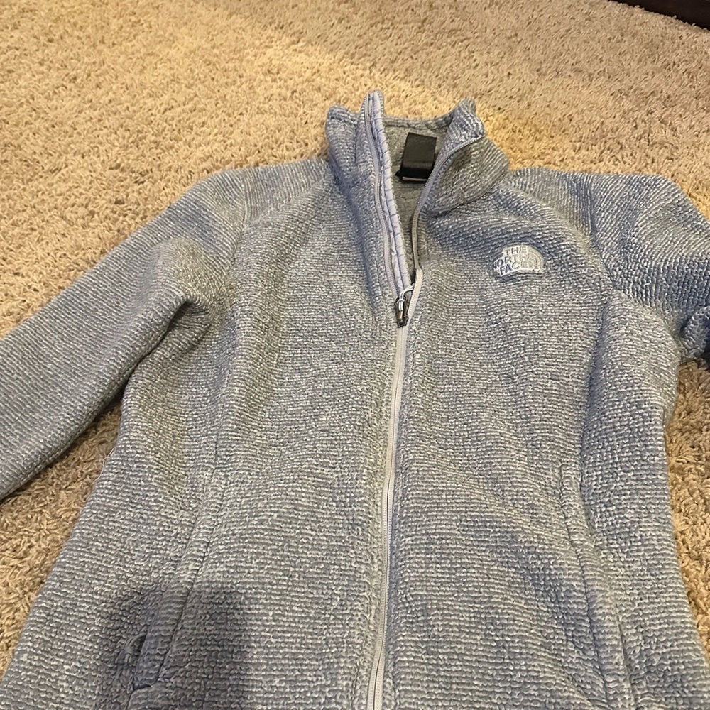 Women’s north face zip up jacket.
